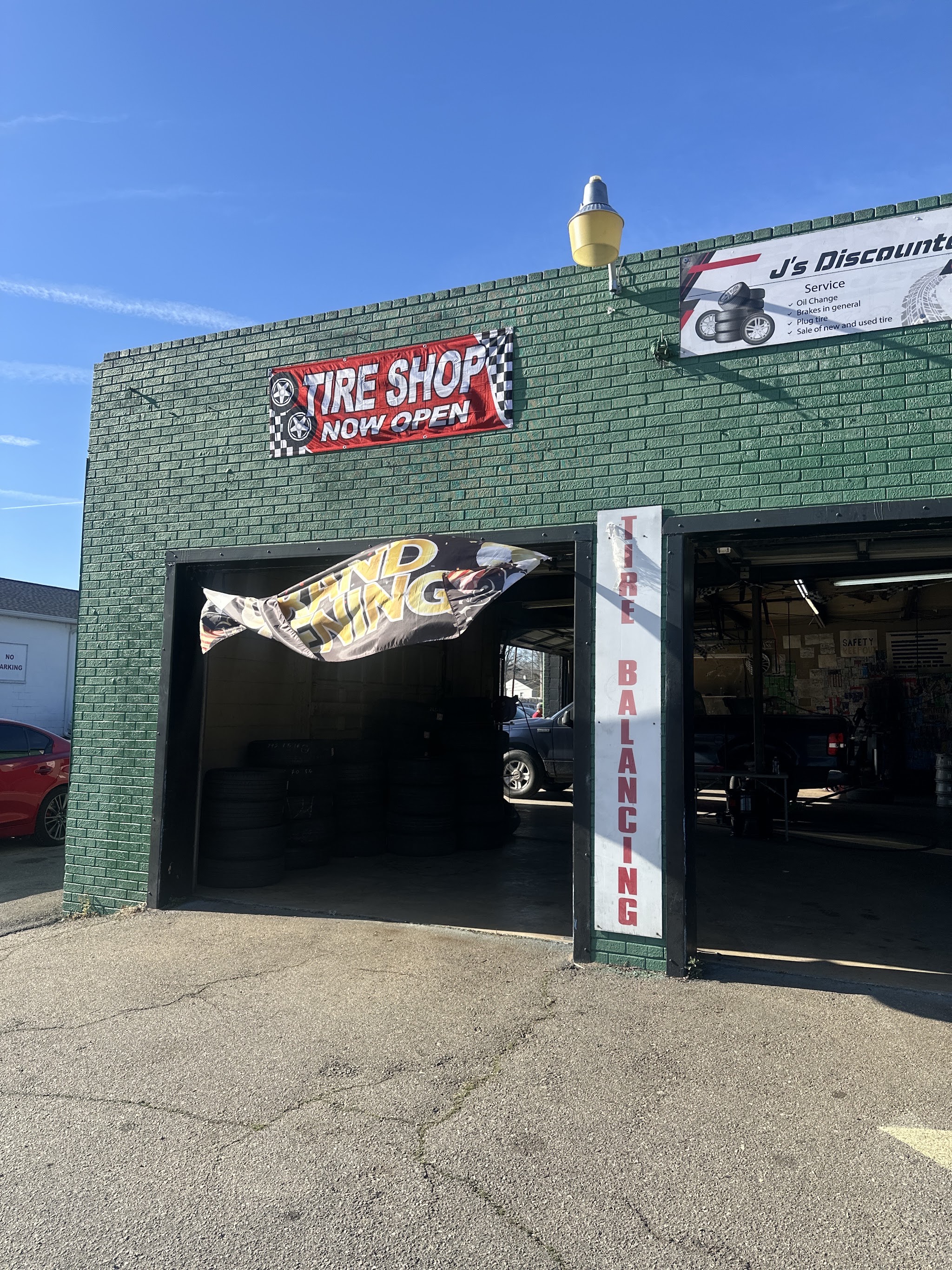 Our green brick shop on Cherry Rd with the tire shop banner and balancing sign