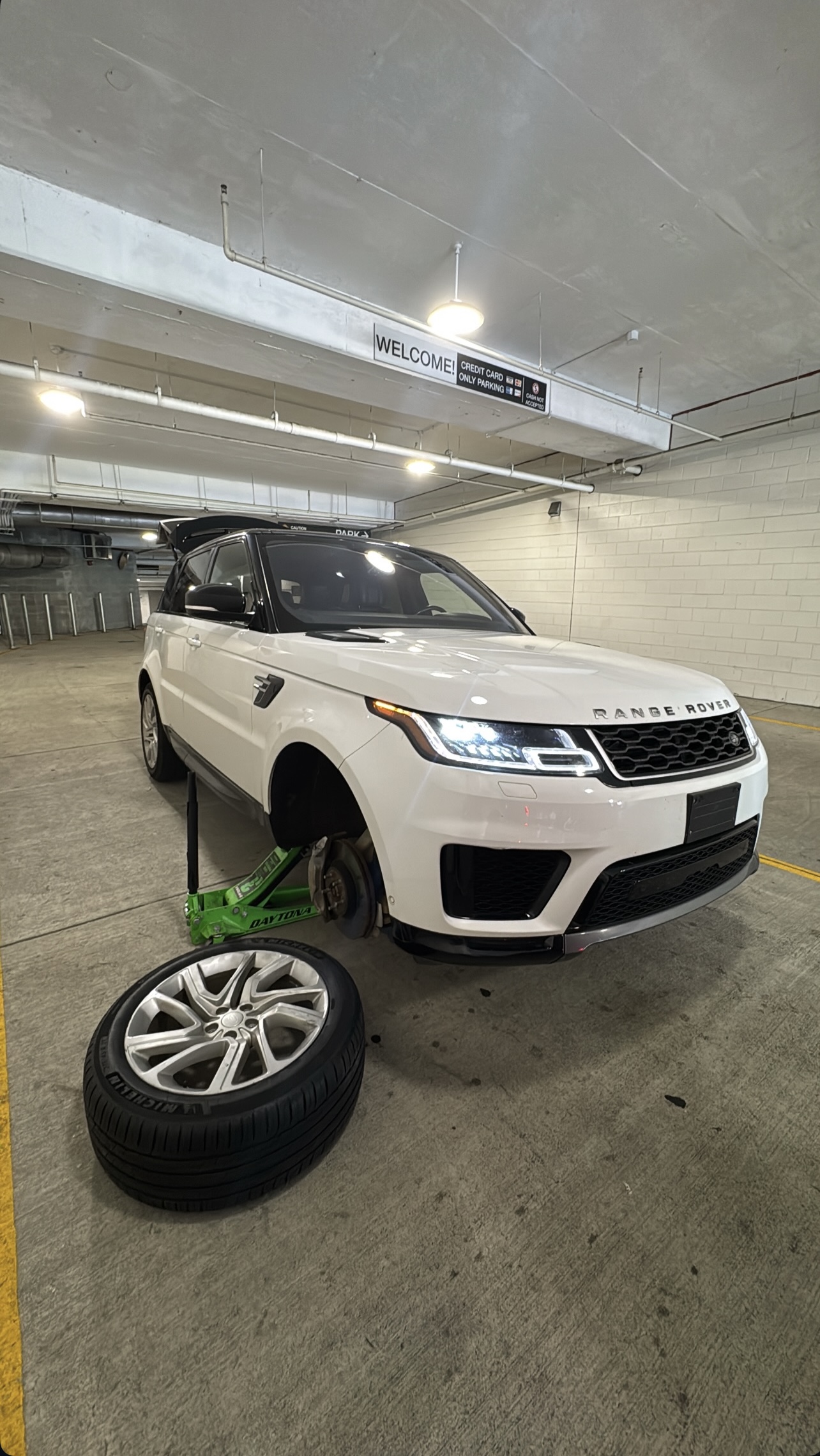 A customer's SUV with a wheel off during service