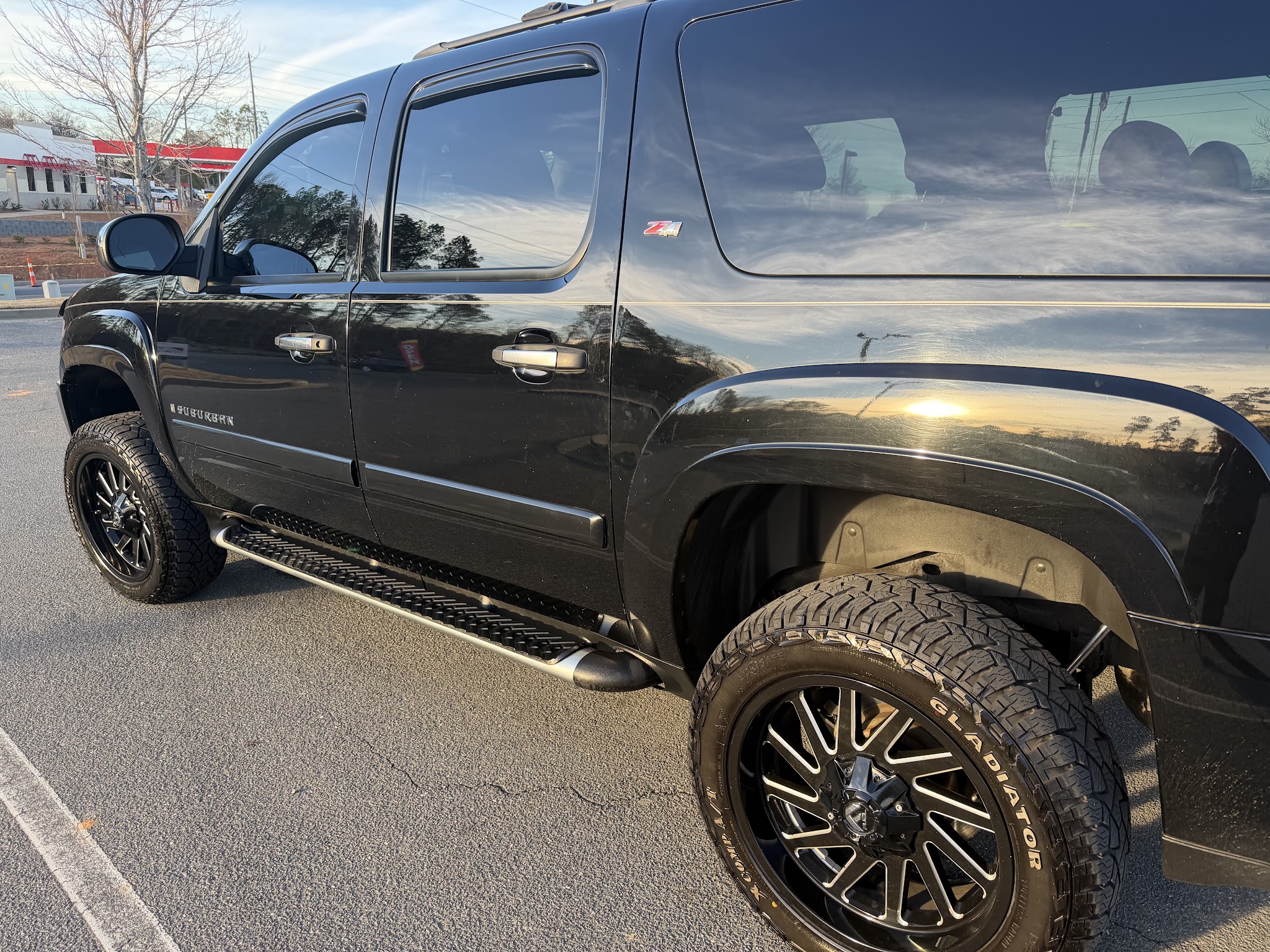 A black SUV with new wheels and tires